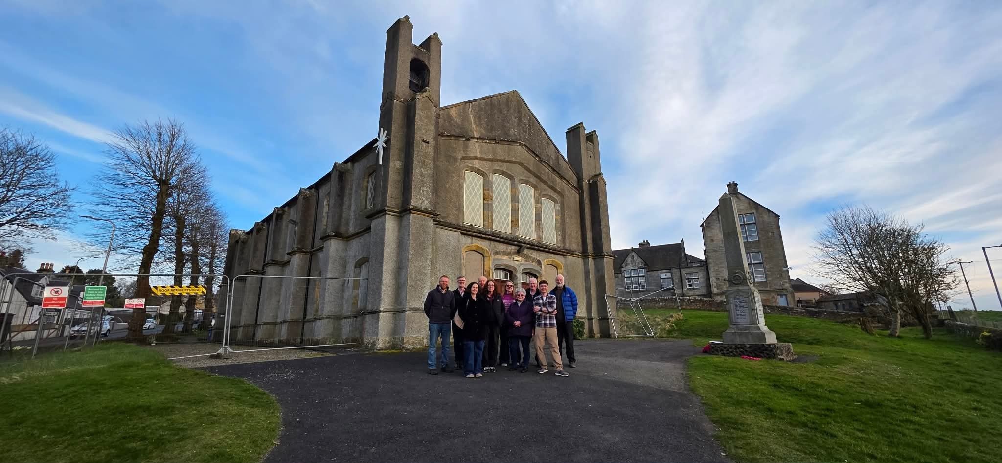 The Saline Kirk Development Group in front of the church buildings